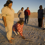 Aboriginal Elders inspecting the footprints - Photograph © Michael Amendolia